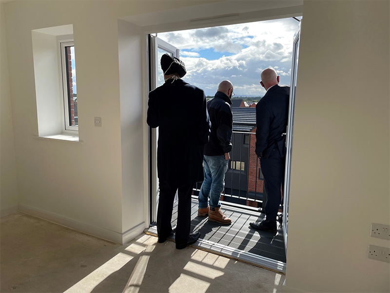Councillors Greg Brackenridge and Councillor Bhupinder Gakhal take a look around the apartment and take in the view with project manager Amin